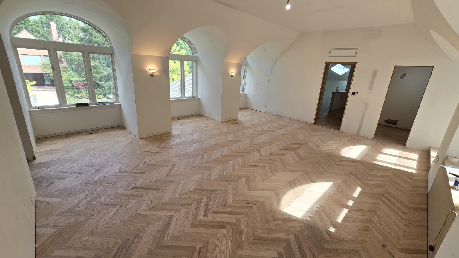 Wide view of installed hardwood floor in a bright, modern space