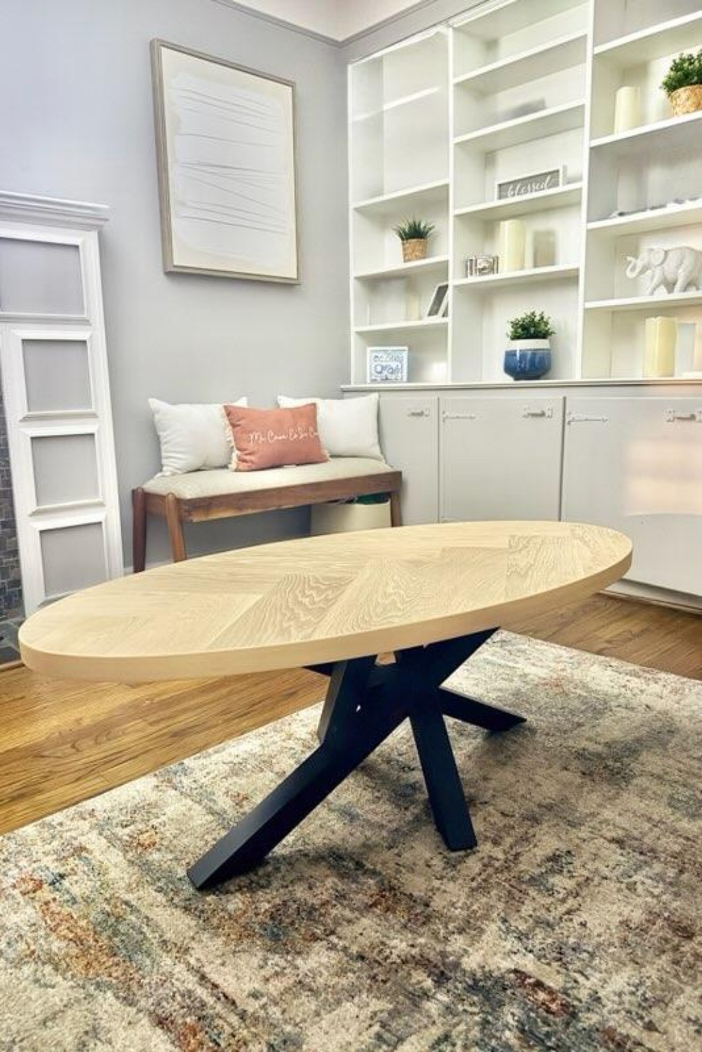 Custom oval dining table with dark sculptural base