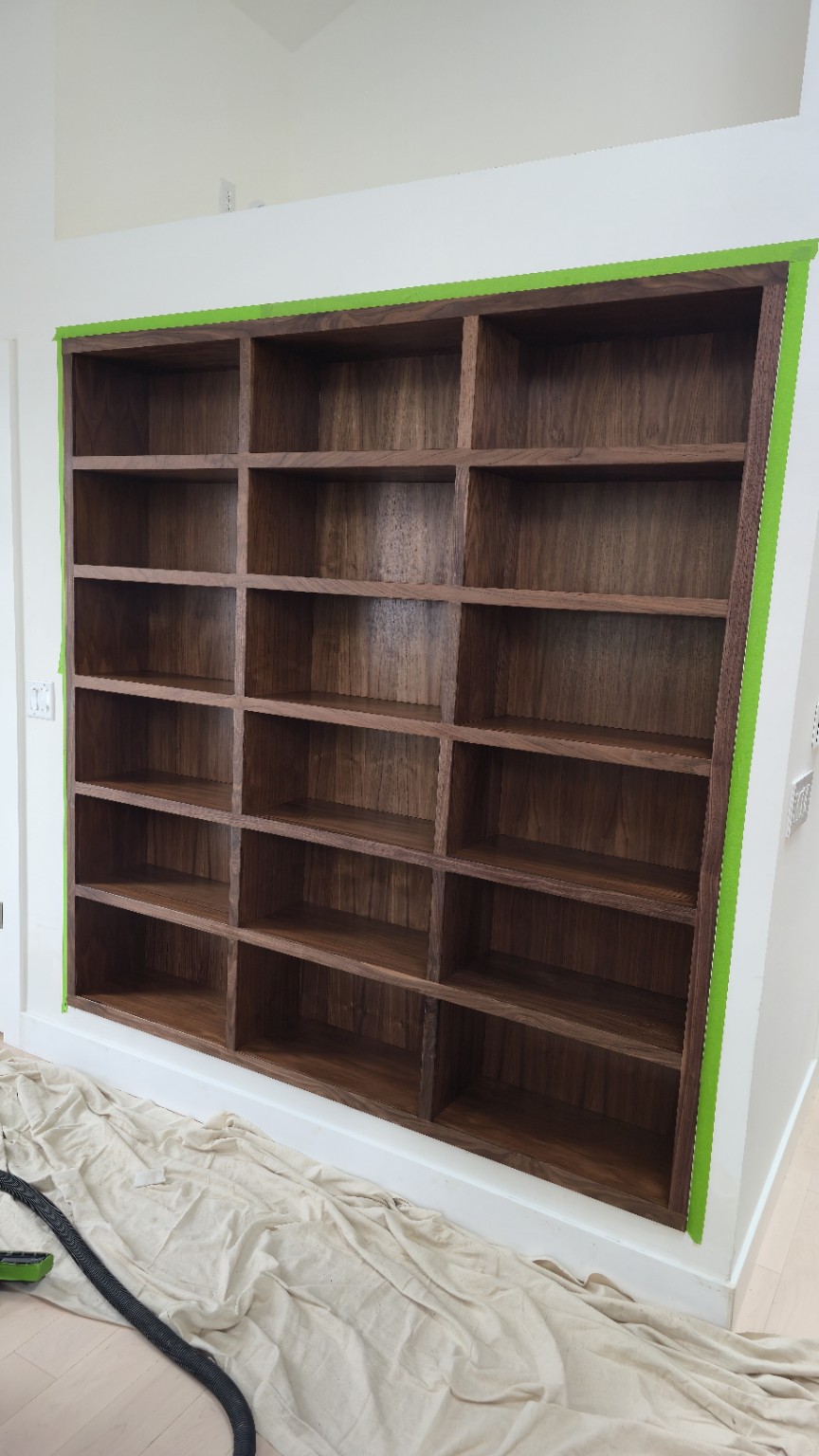 Custom built-in shelving wall in dark hardwood
